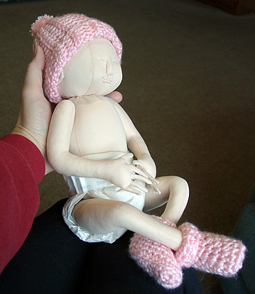 Doll with hat and booties